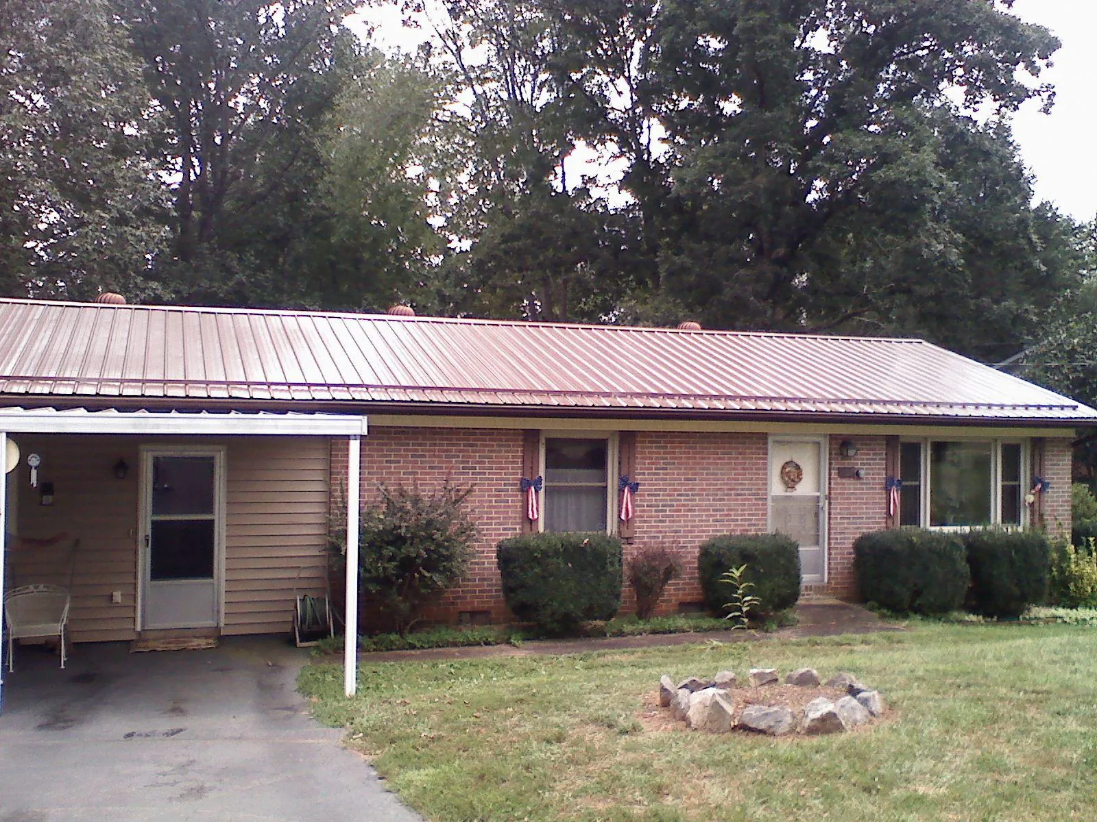 Bronze metal roof and carport on a brick ranch home — Roof Repair work by our crew in Quincy